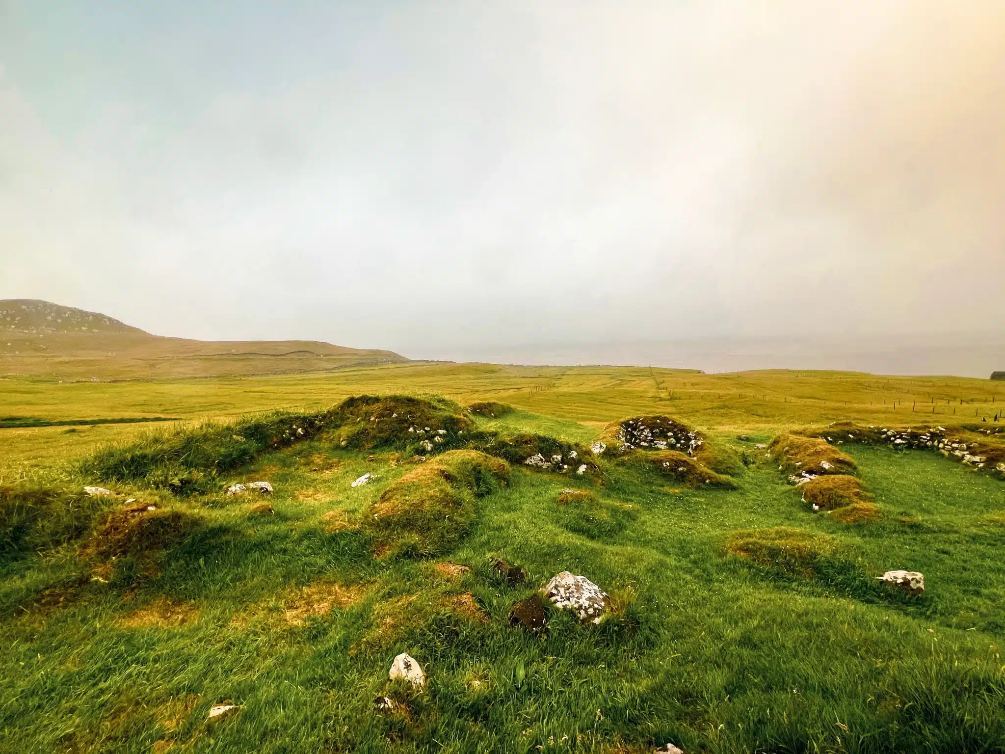 Misty windswept grassy hills with scattered rocks for Green Burial Services in Newport Coast, California